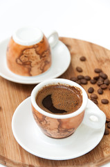 Cup of coffee on the wooden board