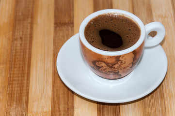 Cup of coffee on the wooden board