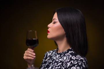 Asian woman with glass of red wine