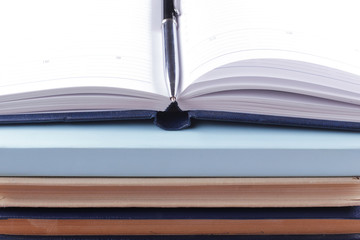 Close-up of open book and pen