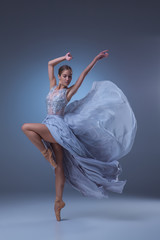 The beautiful ballerina dancing in blue long dress 