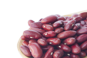 Red beans on wooden spoon isolated on white background