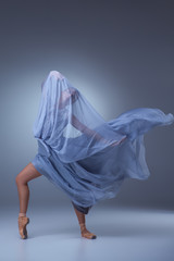 Fototapeta premium The beautiful ballerina dancing in blue long dress 