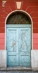old blue ragged shabby wooden door