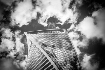 The top of one building of business complex Moscow City in cloud