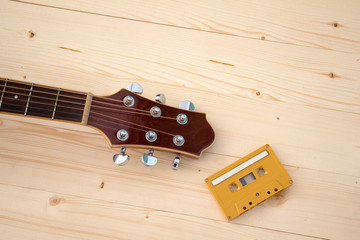 guitar and yellow cassette tape