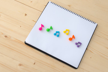 colorful music notes on paper of notebook