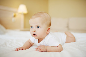 baby boy crawling on the bed