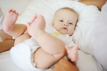 portrait of baby with blue eyes. A child resting on a bed