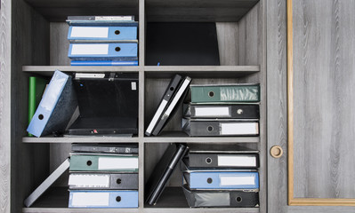 disorderly document file on wood cabinet