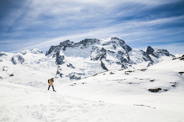 Naklejka na ściany i meble A man taking a film camera in the background of snow mountain.