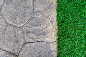 Ornament Stone footpath with pebble and grass in the garden
