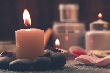 Spa composition with sea salt, candles, soap, shells, creams for face on wooden background. Aromatherapy.