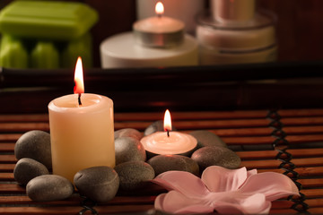 Spa composition with sea salt, candles, soap, shells, creams for face on wooden background. Aromatherapy.