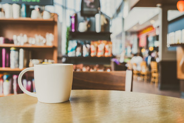 White coffee cup in coffee shop cafe - vintage filter