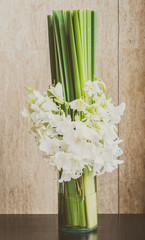 Orchid flower in glass vase - vintage filter