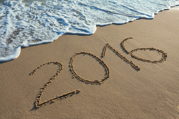 Digit 2016 on coast sand at sunset