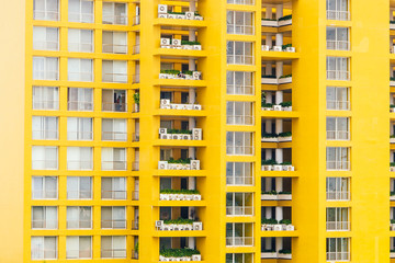 Fototapeta na wymiar Yellow window pattern at apartment building - vintage filter
