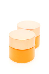 Blank orange cosmetic bottle cream isolated on white background