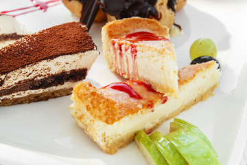 A piece of cheesecake and tiramisu on a plate