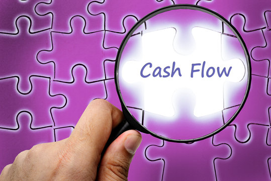 Cash flow word. Magnifier and puzzles.