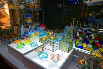 Naklejka na ściany i meble Christmas stand with souvenirs made of colored glass