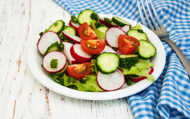 Spring salad with tomato, cucumbers and radish
