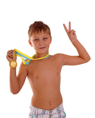 Sport success and win concept - smiling athlete champion child boy hand holding first place victory gold medal award