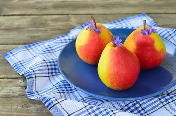 Ripe pears on a blue plate
