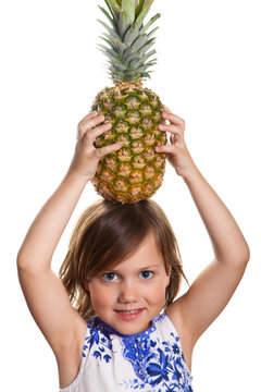 Cute girl with a pineapple on her head