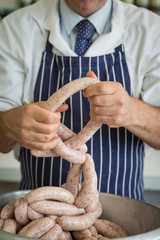 Professional butcher making sausages