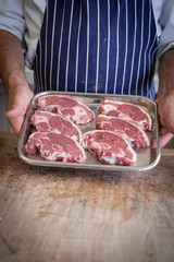 lamb steaks on a metal dish