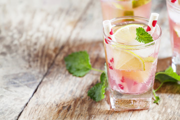 Pink cocktail with lime and mint, selective focus