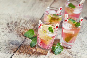 Pink cocktail with lime and mint, selective focus