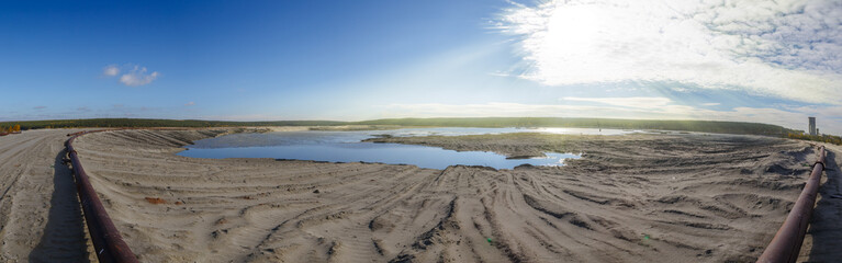 Fototapeta na wymiar panorama sun over the sands in an industrial career