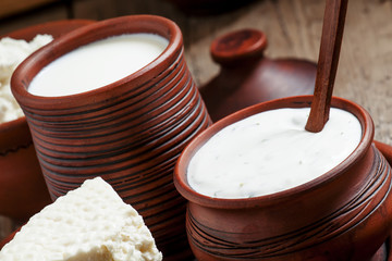 White cream sauce in brown clay pot  in a rustic style, selectiv