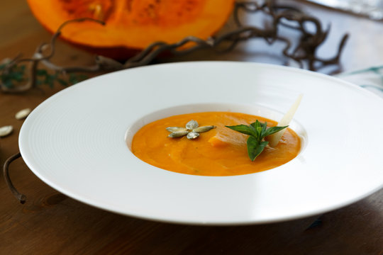 Pumpkin soup in a plate closeup