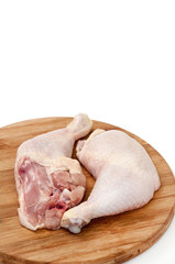 Chicken drumsticks on the wooden board ready for cooking