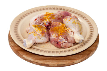 Chicken drumsticks seasoned with curry and ready for frying