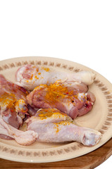 Chicken drumsticks seasoned with curry and ready for frying