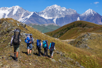 Fototapeta premium Group of tourists with large backpacks are on mountain