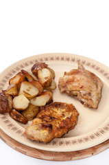 Fried young potatoes and chicken meat on the plate