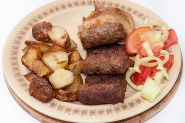 Young potaotes kebabs fried pork tomato salad paprika