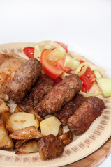 Young potaotes kebabs fried pork tomato salad paprika