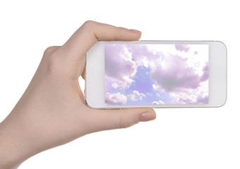Hand holding mobile smart phone with sky in screen. Cloud computing concept