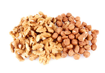 Pile of walnut kerneks and peeled hazelnuts isolated