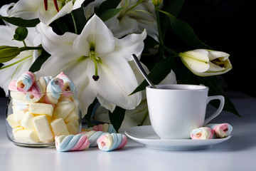 Morning cup of tea, white lily, colored marshmallow