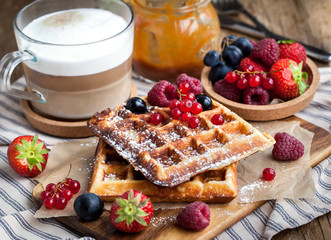 Belgian waffles with fresh berries and cappuccino