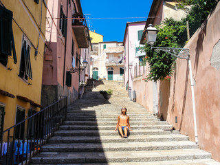 Young woman with sunglasses in Italian medieval town
