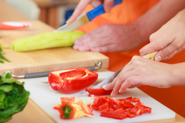 Couple preparing fresh vegetables salad. Diet